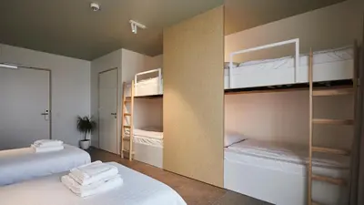 two beds in a room with bunk beds at Het Kasterhuis in Wetteren