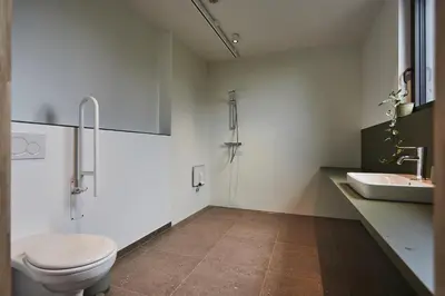 a bathroom with a toilet and a sink at Het Kasterhuis in Wetteren