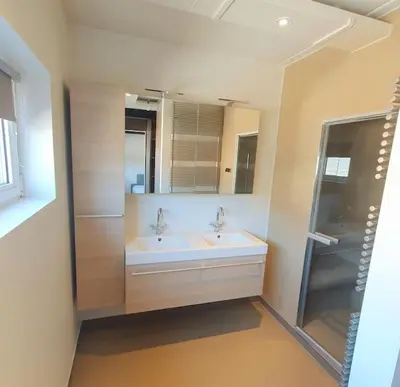 a bathroom with two sinks and a large mirror at Portus Ganda in Ghent