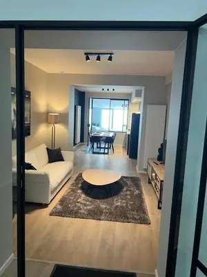 a living room with a couch and a table at Appartement Martine in Brussels