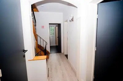 a hallway with a hallway leading into a house at Capstay Sweet home in Willebroek