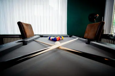 two baseball bats and balls on a ping pong table at Capstay Sweet home in Willebroek