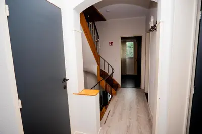 a hallway of a house with a stairway at Capstay Sweet home in Willebroek