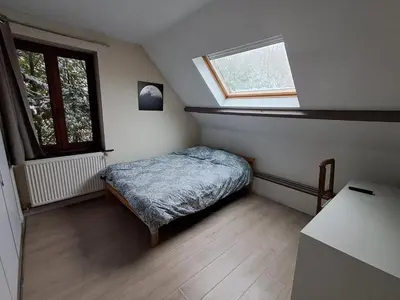 a small bedroom with a bed and a window at Maison d'hôte in Grez-Doiceau