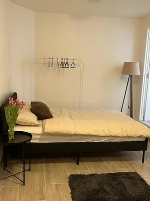 a large bed in a room with a table at Studio n1 Bruxelles Centre Ville in Brussels