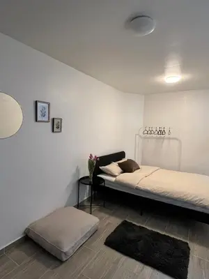 a bedroom with a bed and a ottoman at Studio n1 Bruxelles Centre Ville in Brussels