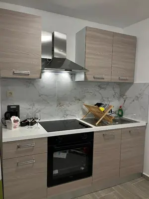 a kitchen with wooden cabinets and a stove top oven at Studio n1 Bruxelles Centre Ville in Brussels