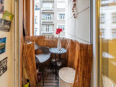 a balcony with a vase with a red flower on it at Luxe Serene Residence in Brussels