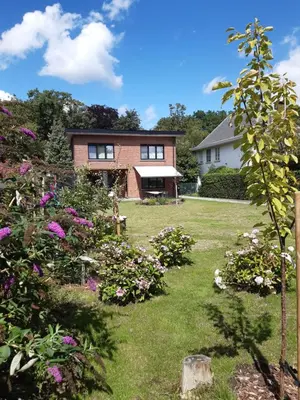 a house with a yard with flowers at TML Vintage Villa 80 in Boom