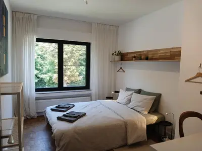 a bedroom with a bed and a large window at TML Vintage Villa 80 in Boom