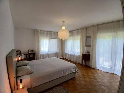 a bedroom with a large bed and a chandelier at TML Vintage Villa 80 in Boom