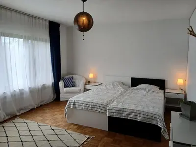 a white bedroom with a bed and a chair at TML Vintage Villa 80 in Boom