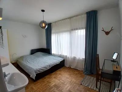 a bedroom with a bed and a sink and a window at TML Vintage Villa 80 in Boom