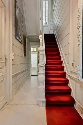 a red carpeted staircase in a home with a white stair case at Le Papillon Antwerp Suite 3 in Antwerp
