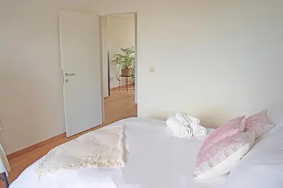 a bedroom with a white bed with two pillows on it at Astrid Sauna Appartement Antwerp in Antwerp