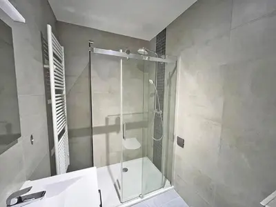 a shower with a glass door in a bathroom at Astrid Sauna Appartement Antwerp in Antwerp