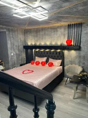 a bedroom with a bed with red decorations on it at Jungle suite romantic - private Jacuzzi - in Brussels