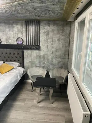 a bedroom with a bed and a table and chairs at Jungle suite romantic - private Jacuzzi - in Brussels