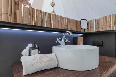 a bathroom with a sink and a towel on a counter at Tipi Bo Deluxe in Kaprijke