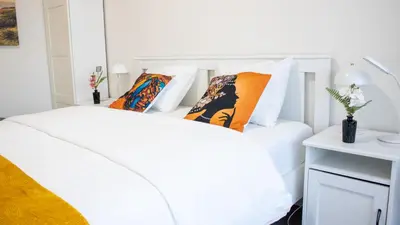 a white bed with pillows on it in a bedroom at Atomium Brussels Expo Stay in Brussels
