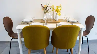 a dining room table with yellow chairs and a white table at Atomium Brussels Expo Stay in Brussels