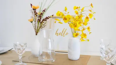 four vases with yellow flowers in them on a table at Atomium Brussels Expo Stay in Brussels