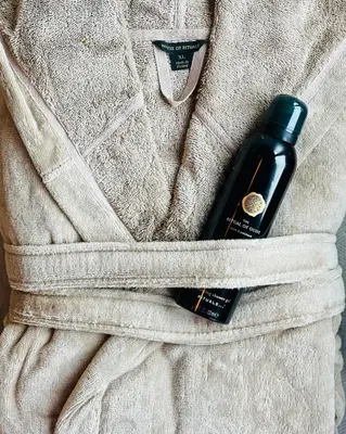 a bottle of soap in the pocket of a sweater at Luxurious Escape - Room LoveSerenity with pool and jacuzzi in Brussels