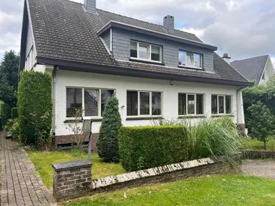 a white house with a black roof at Zonnebos in Kraainem