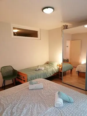 a hotel room with two beds and a mirror at Antwerp horizon in Borsbeek