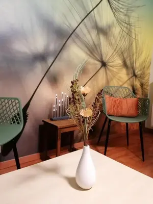 a white vase with flowers and candles on a table at Antwerp horizon in Borsbeek