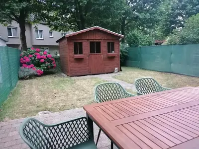 a picnic table and a dog house in a backyard at Antwerp horizon in Borsbeek
