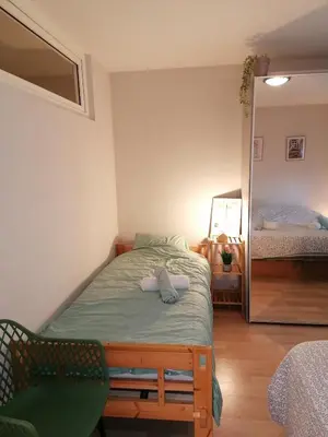 a small bedroom with a bed and a mirror at Antwerp horizon in Borsbeek