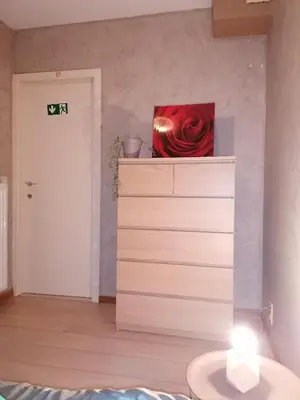 a room with a red rose on top of a dresser at Antwerp horizon in Borsbeek