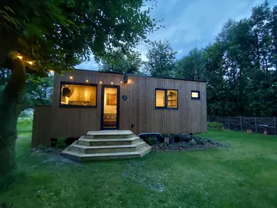 a tiny house with stairs in a yard at Zen huisje in Turnhout