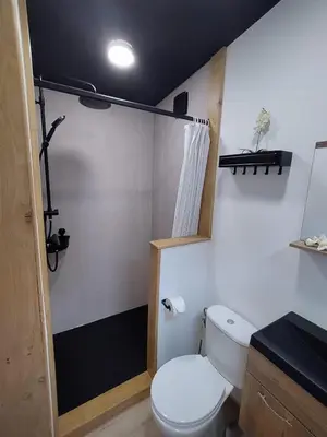 a bathroom with a white toilet in a room at Zen huisje in Turnhout