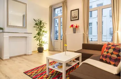 a living room with a couch and a table at Central Brussel - steps Grand Place - local vibrant neighbourhood in Brussels