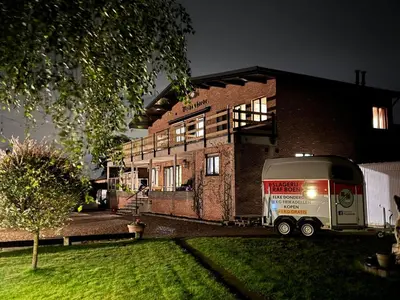 a white truck parked in front of a brick building at Welkomhoeve in Grobbendonk