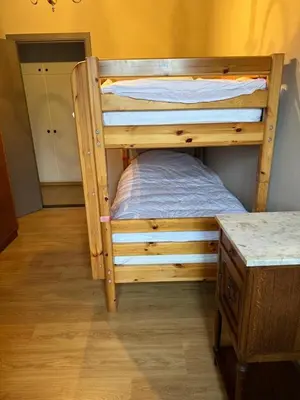 a wooden bunk bed in a room with a counter at Welkomhoeve in Grobbendonk