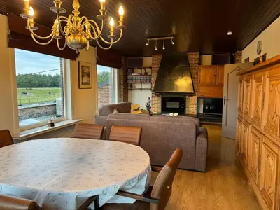 a kitchen and living room with a table and a couch at Welkomhoeve in Grobbendonk