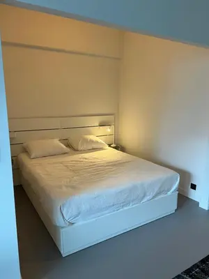 a bedroom with a white bed with a white bed frame at Studio 59 in Antwerp