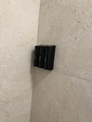 a black remote control sitting on a wall at Studio 59 in Antwerp