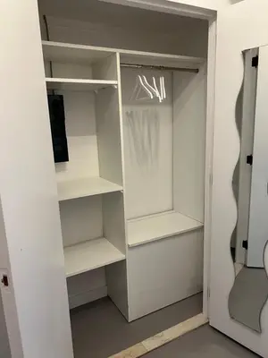 a walk in closet with white shelves at Studio 59 in Antwerp
