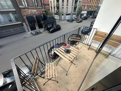 a balcony with a table and chairs on a street at cozy casa d'anvers op een unieke toplocatie in Antwerp