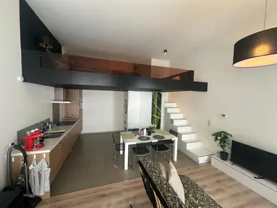 a kitchen and living room with a loft at cozy casa d'anvers op een unieke toplocatie in Antwerp