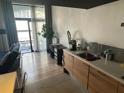 a kitchen with a sink and a living room at cozy casa d'anvers op een unieke toplocatie in Antwerp