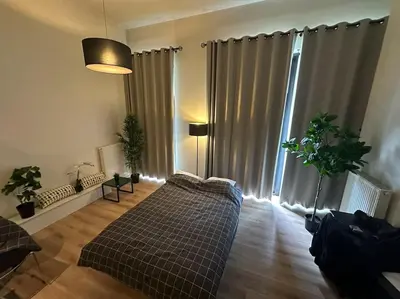 a living room with a couch and a large window at cozy casa d'anvers op een unieke toplocatie in Antwerp