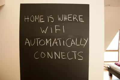 a chalkboard sign that says home is where wifi automatically connects at B&B Moensberg in Brussels