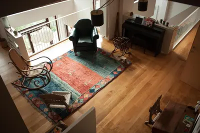 an overhead view of a living room with a piano and chairs at B&B Moensberg in Brussels