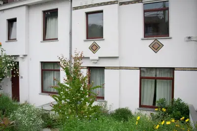 a white building with red windows at B&B Moensberg in Brussels