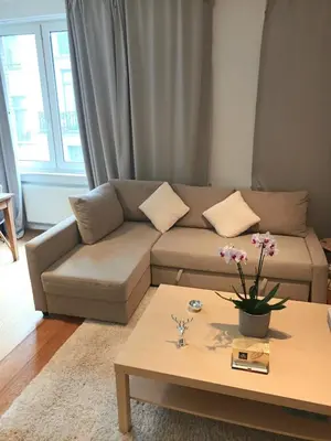 a living room with a couch and a coffee table at Beautiful 2 bedroom apartment in Place Flagey bxl in Brussels